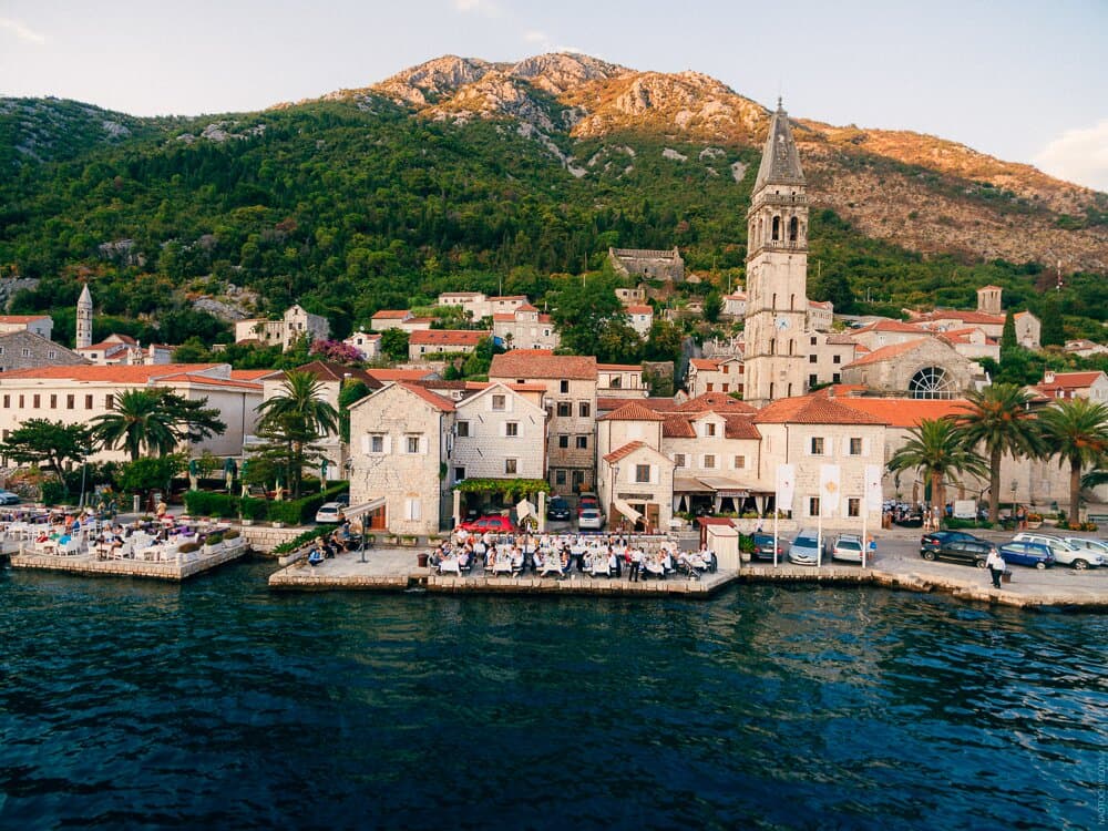 Aerial view of Perast and the terrace of the Conte Hotel on the seashore