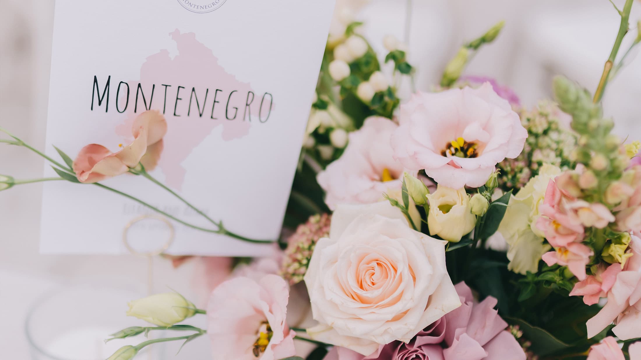 Bouquet of flowers with a pamphlet titled 'Montenegro'.