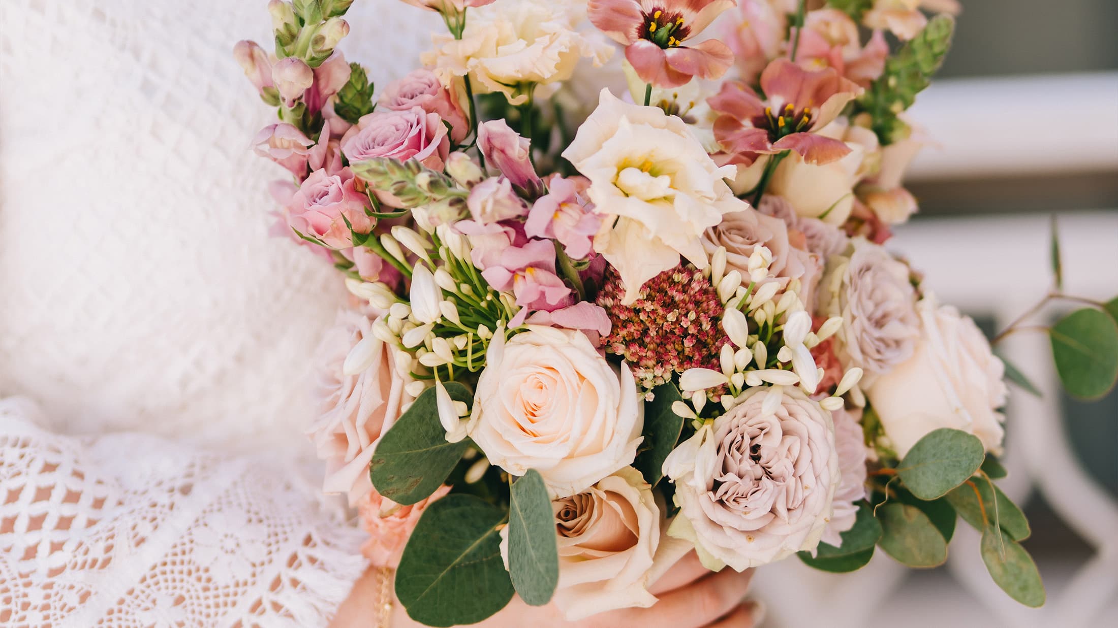 Close-up of a woman holding a bouquet of flowers.